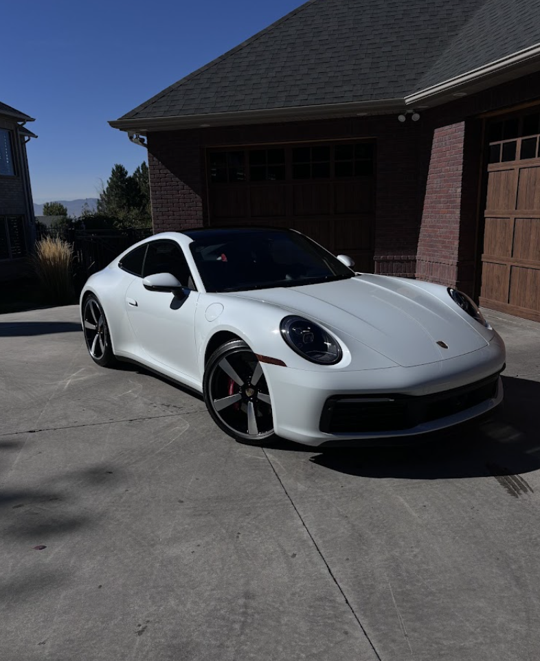 White sports car detailed and gleaming outside a Utah Valley home